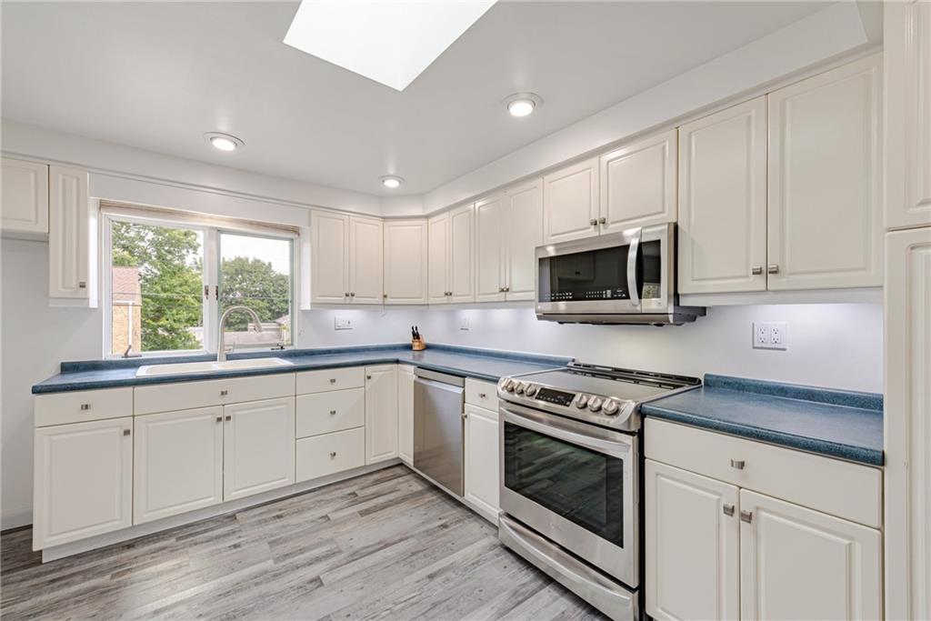 9746 McClellan Street North Huntingdon, PA 15642 - Photo 13 of 30 a kitchen with granite countertop white cabinets white stainless steel appliances and sink