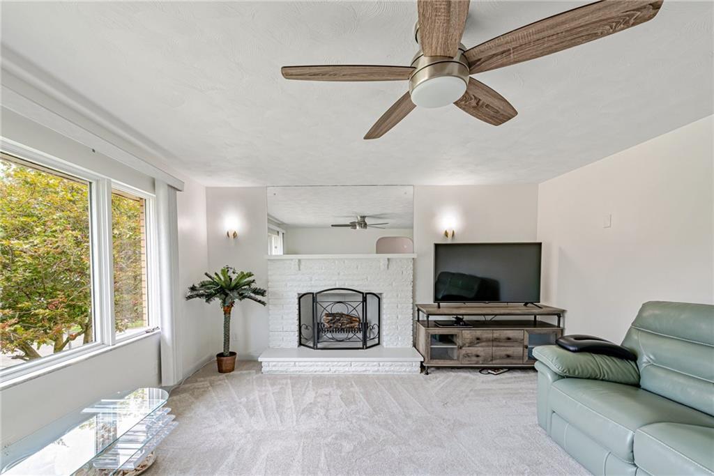 9746 McClellan Street North Huntingdon, PA 15642 - Photo 6 of 30 a living room with furniture a flat screen tv and a fireplace