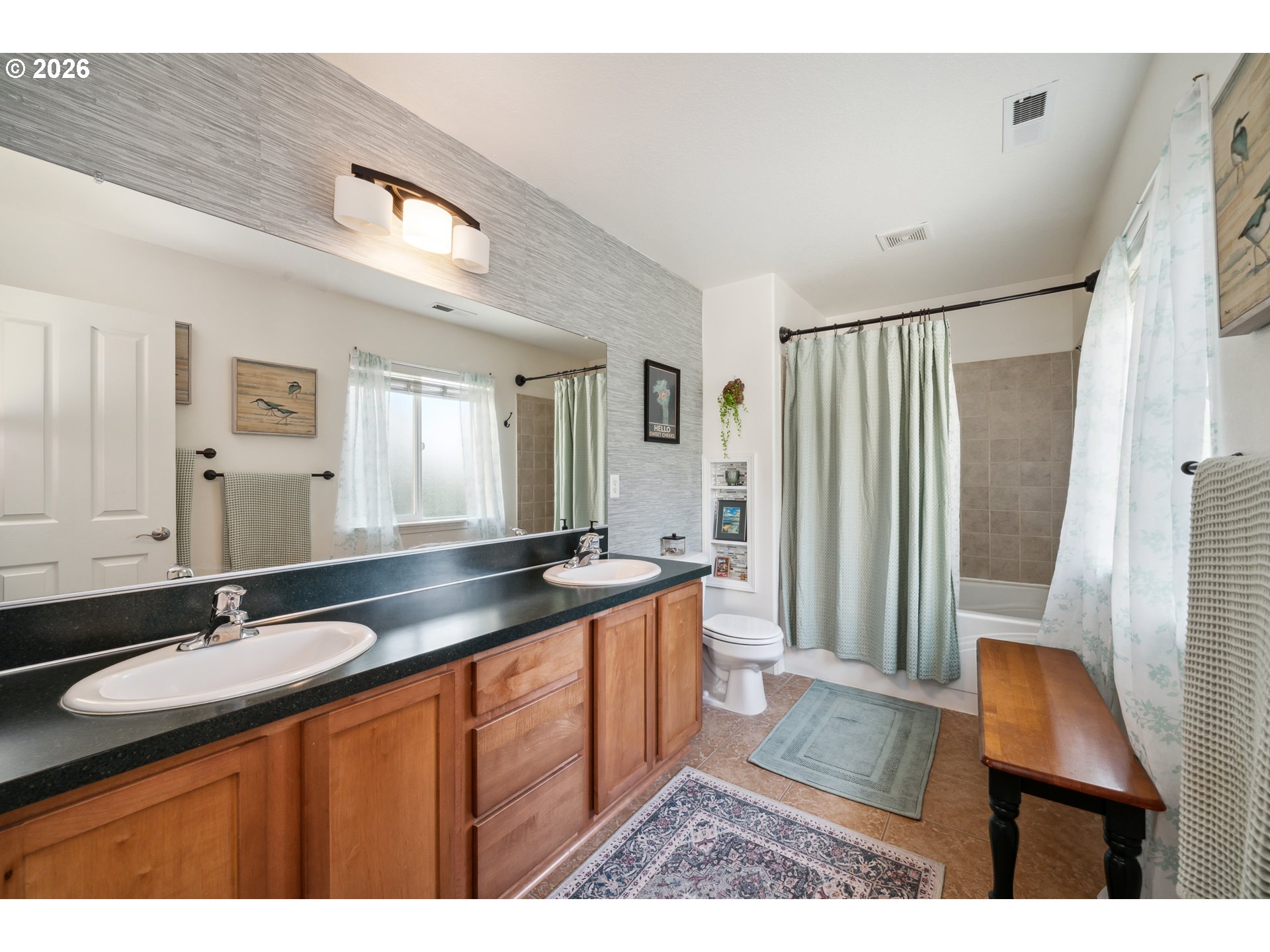 4300 Sequoia Loop Netarts, OR 97141 - Photo 23 of 39 a bathroom with a granite countertop sink a mirror a vanity and a shower