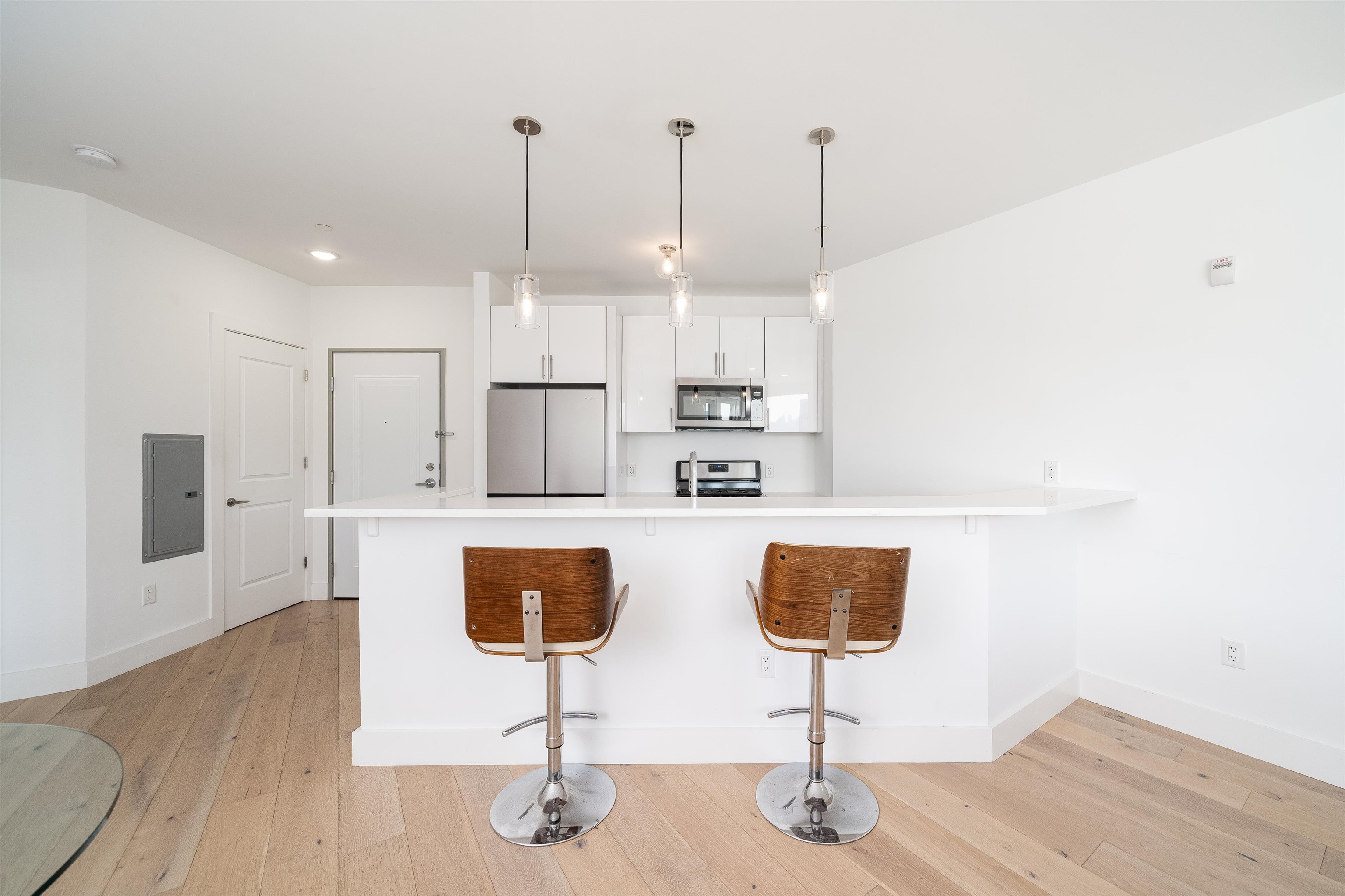 8621 River Road, Unit 6A North Bergen, NJ 07047 - Photo 11 of 42 a kitchen with stainless steel appliances kitchen island granite countertop a sink a refrigerator and chairs