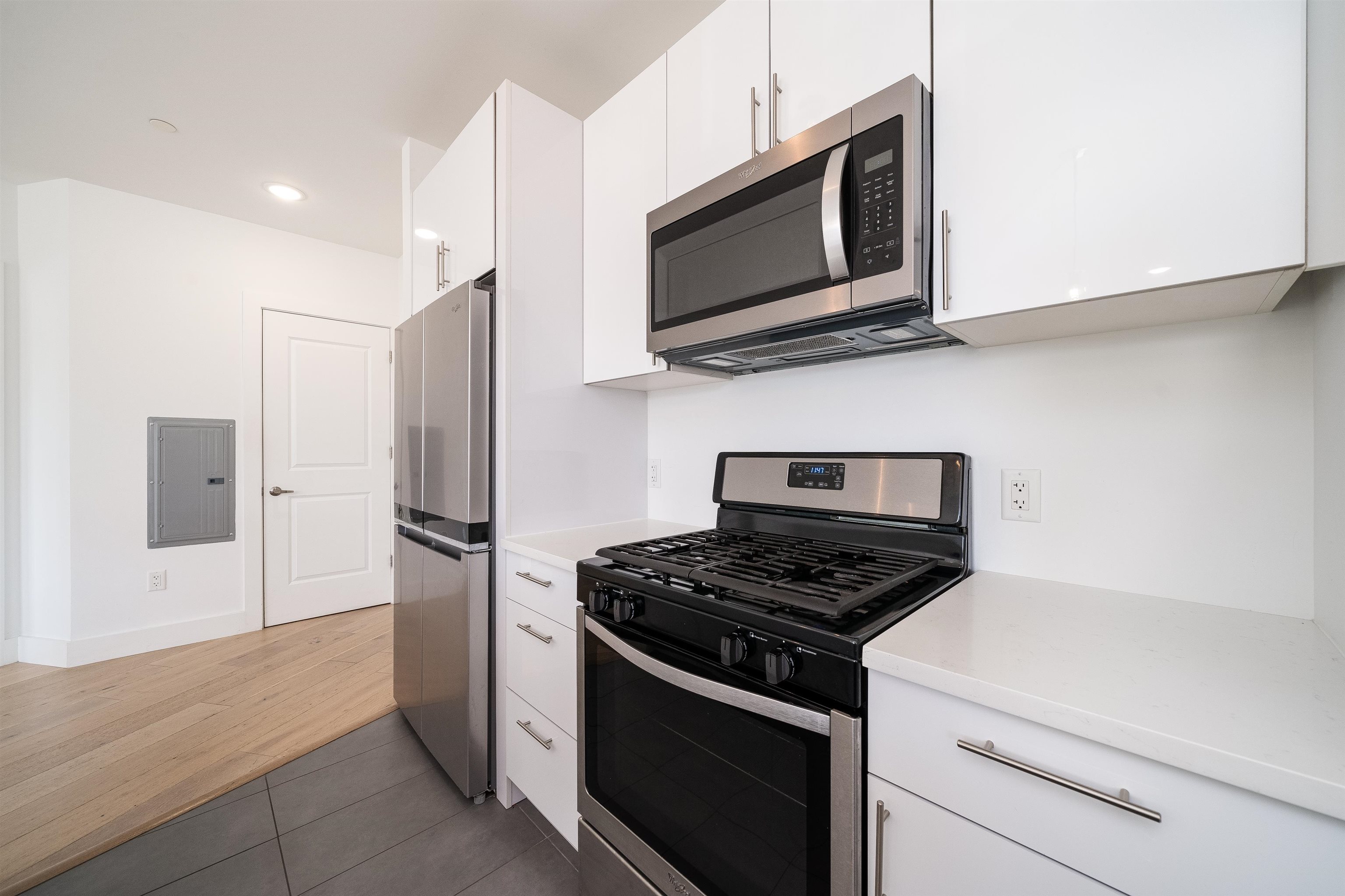 8621 River Road, Unit 6A North Bergen, NJ 07047 - Photo 10 of 42 a kitchen with stainless steel appliances white cabinets and a stove top oven