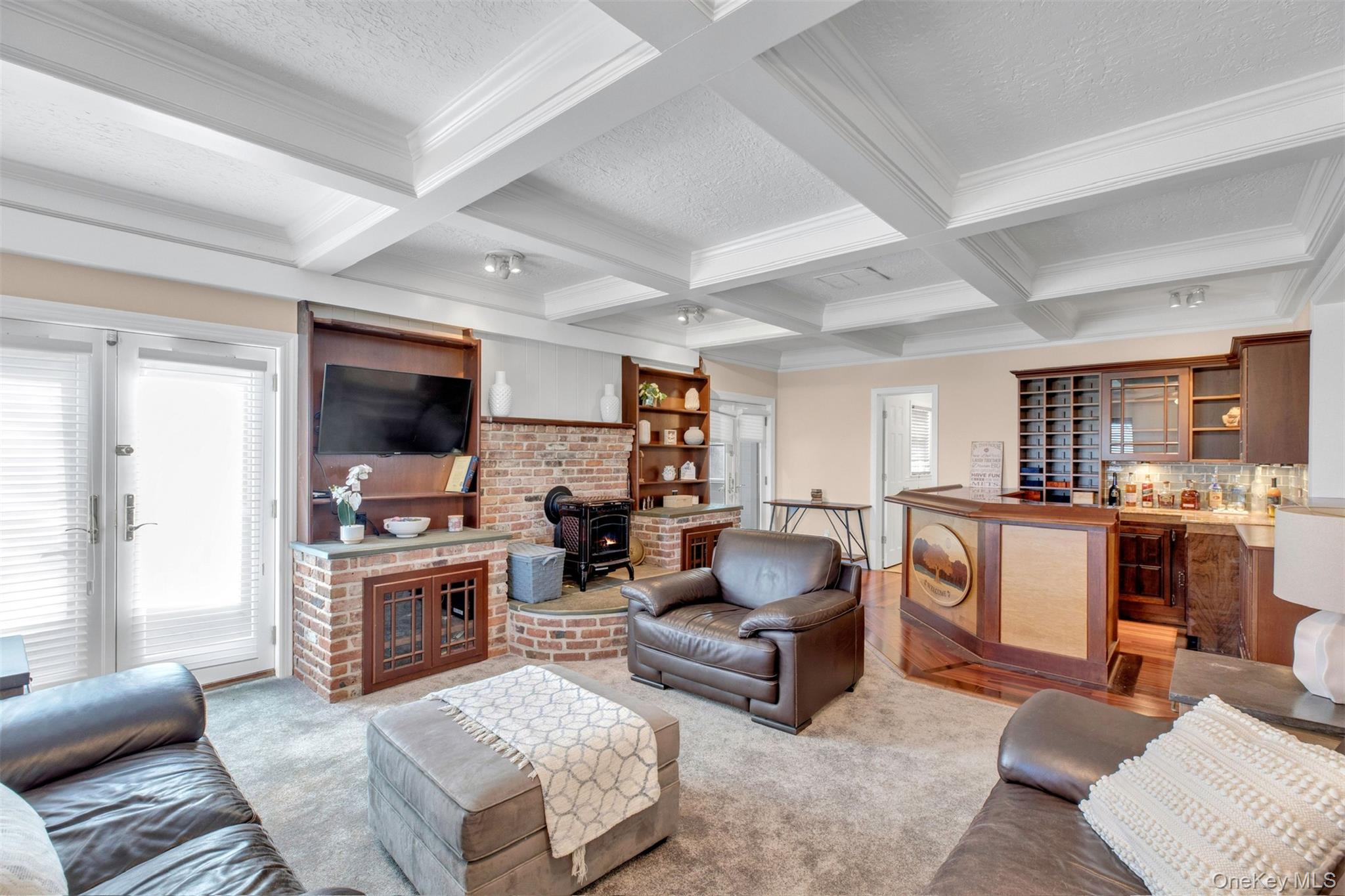 345 Colonial Road Southold, NY 11971 - Photo 12 of 43 a living room with furniture a fireplace and a flat screen tv