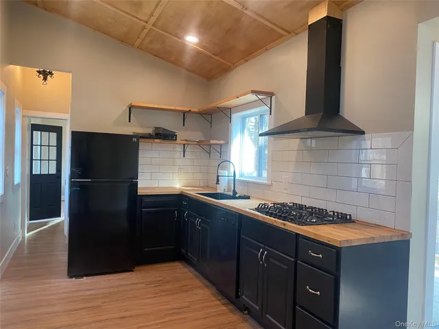 a kitchen with stainless steel appliances granite countertop a refrigerator and a stove