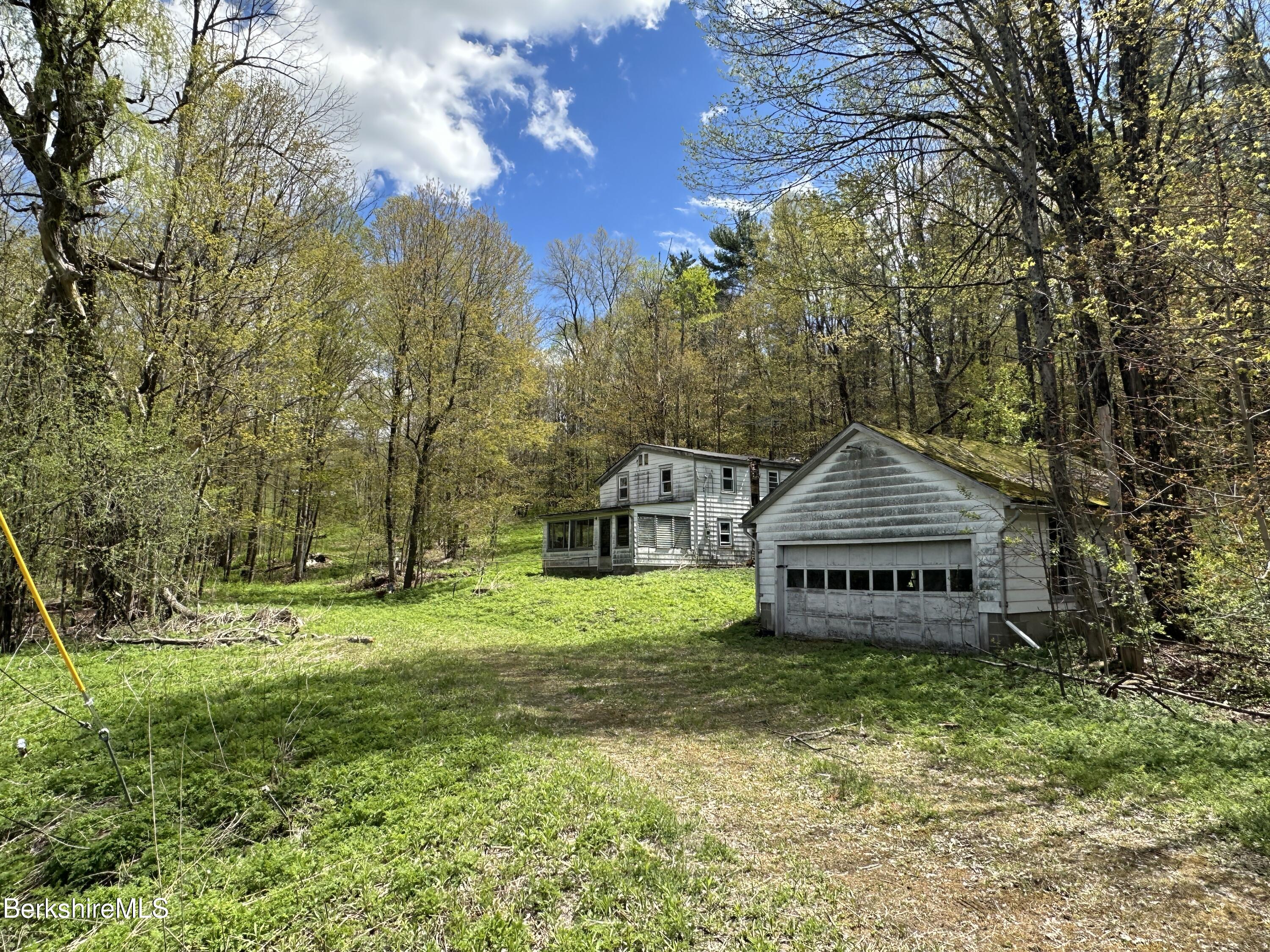 2447 State Road Richmond, MA 01254 - Photo 4 of 13 a front view of a house with a yard