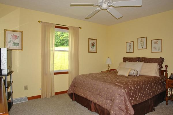 215 W Road Blue Ridge, VA 24064 - Photo 28 of 47 a bedroom with a large bed and a window