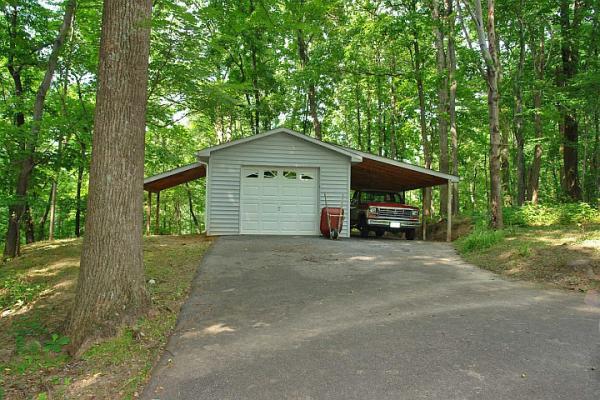 215 W Road Blue Ridge, VA 24064 - Photo 41 of 47 a front view of a house with a garden and trees