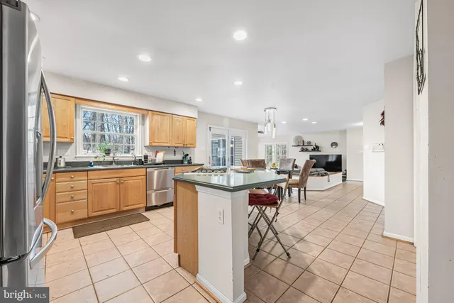 a kitchen with a sink and chairs