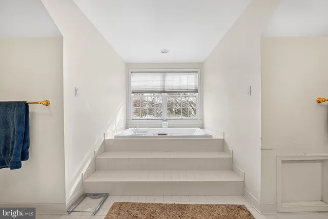a view of staircase with white walls and a window