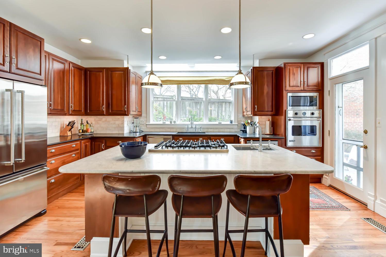645 E Street Southeast Washington, DC 20003 - Photo 17 of 57 a kitchen with a table chairs sink and refrigerator