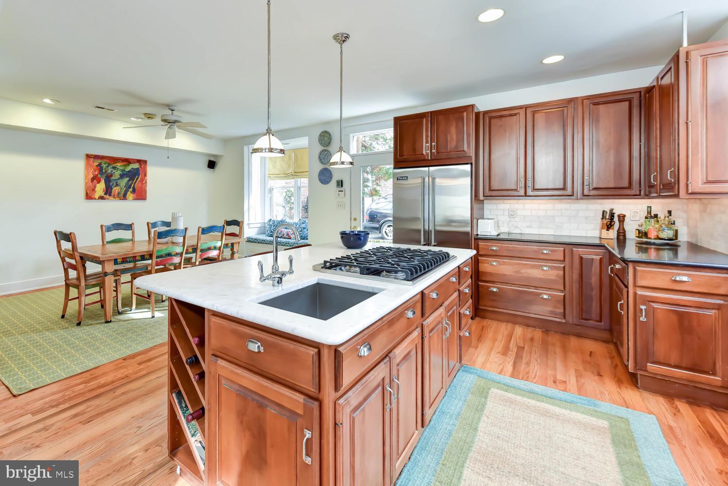 645 E Street Southeast Washington, DC 20003 - Photo 19 of 57 a kitchen with stainless steel appliances granite countertop a sink a stove and a refrigerator