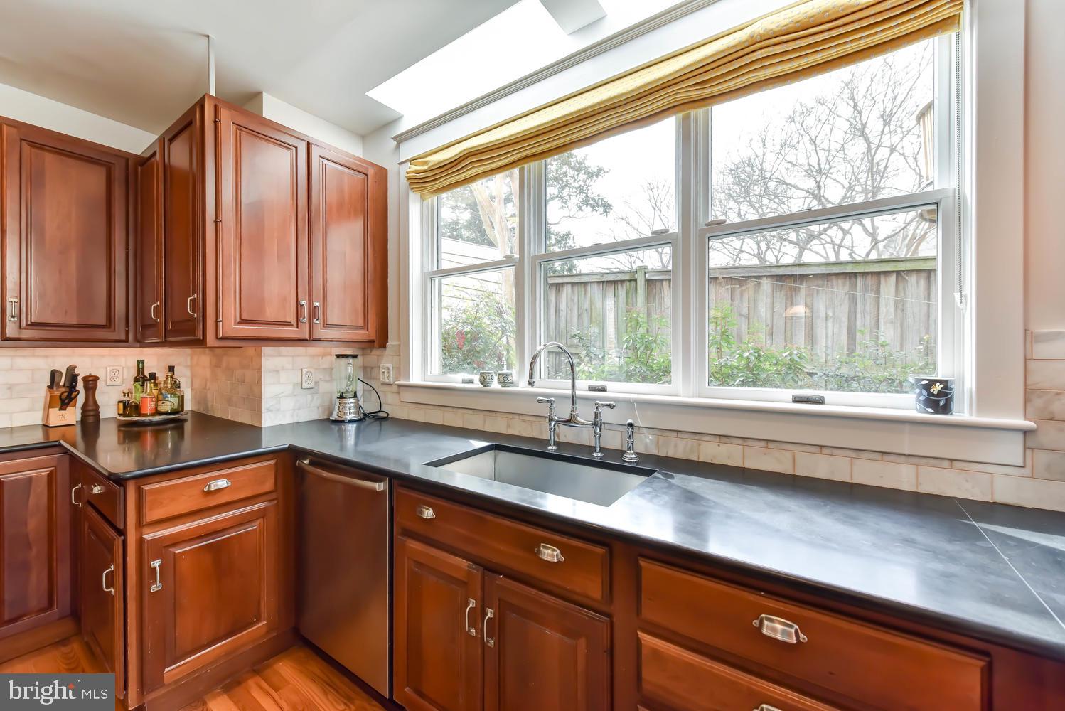 645 E Street Southeast Washington, DC 20003 - Photo 20 of 57 a kitchen with granite countertop a sink and a window