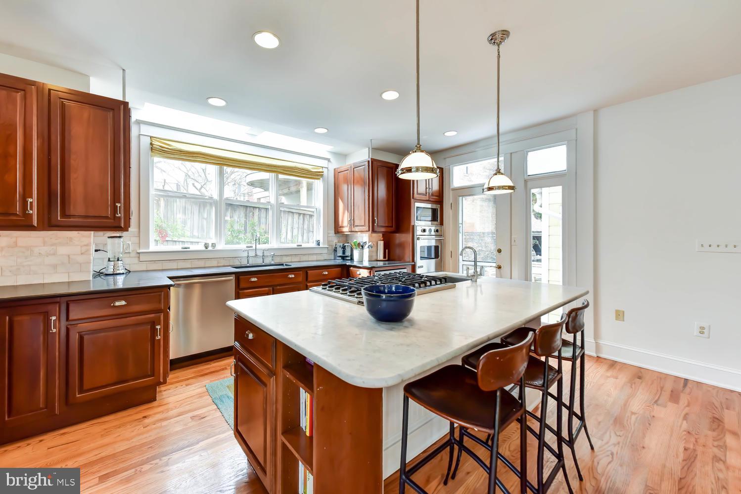645 E Street Southeast Washington, DC 20003 - Photo 22 of 57 a kitchen with a sink and wooden cabinets