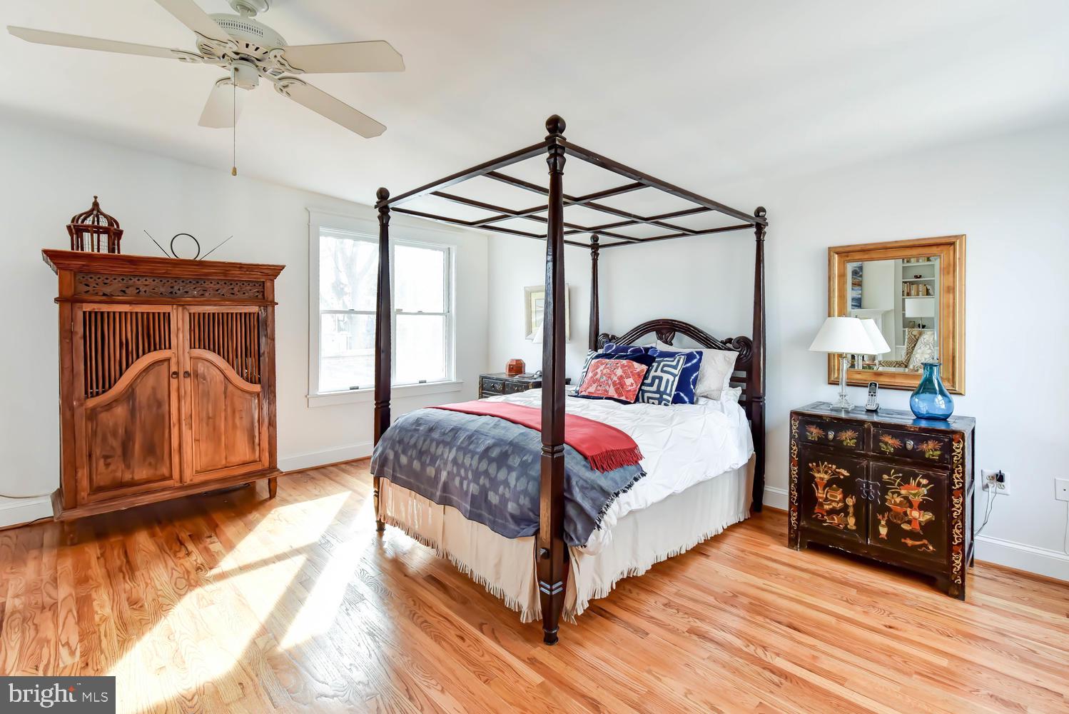 645 E Street Southeast Washington, DC 20003 - Photo 27 of 57 a bedroom with a bed a chandelier and dresser