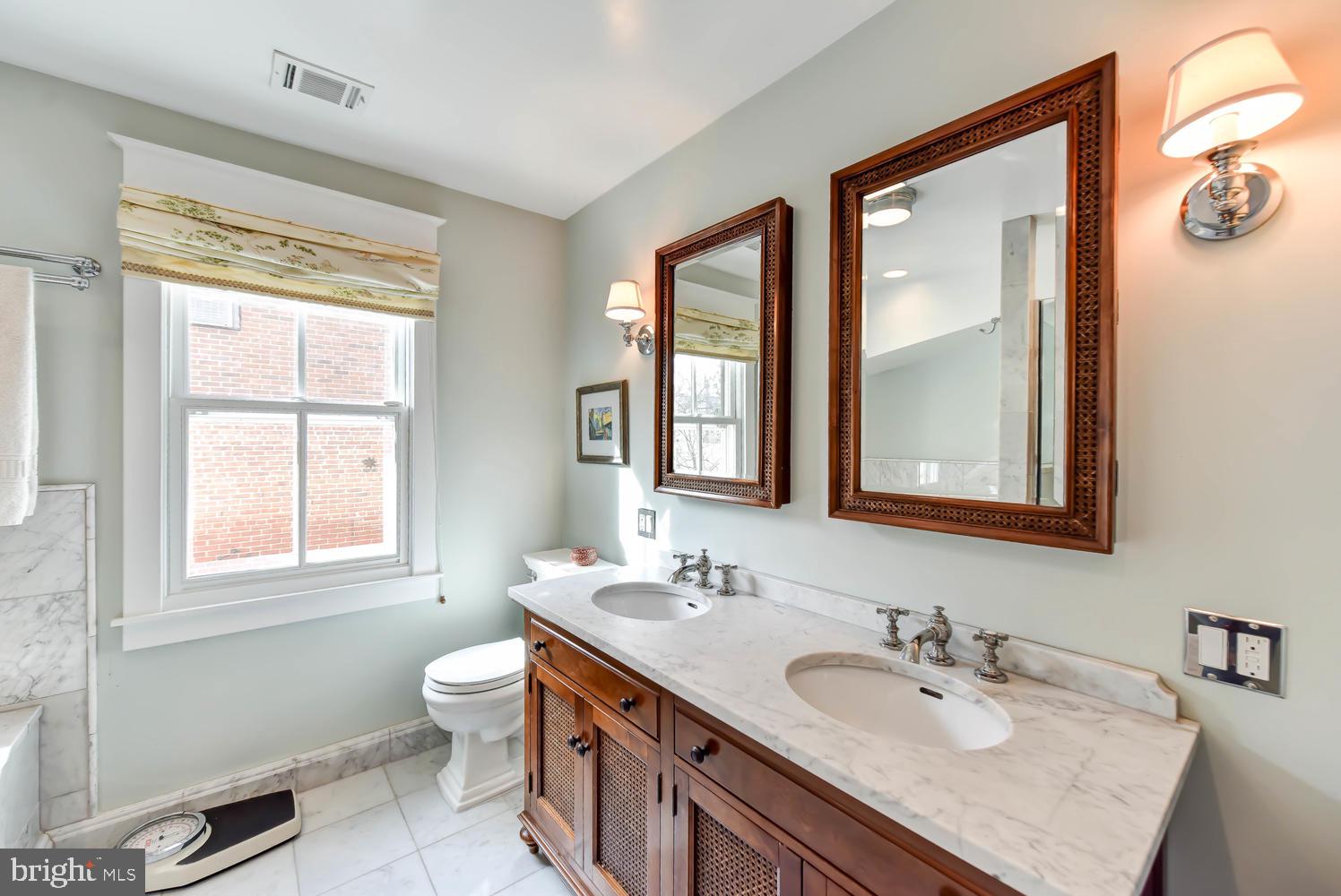 645 E Street Southeast Washington, DC 20003 - Photo 33 of 57 a bathroom with 2 sink double vanity and a toilet