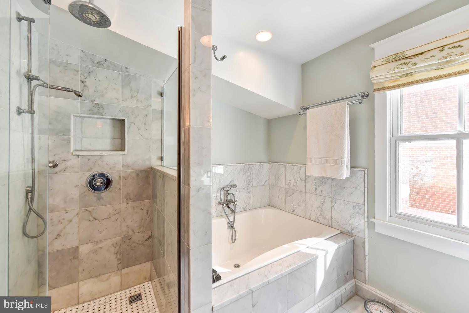 645 E Street Southeast Washington, DC 20003 - Photo 34 of 57 a bathroom with a tub shower and sink