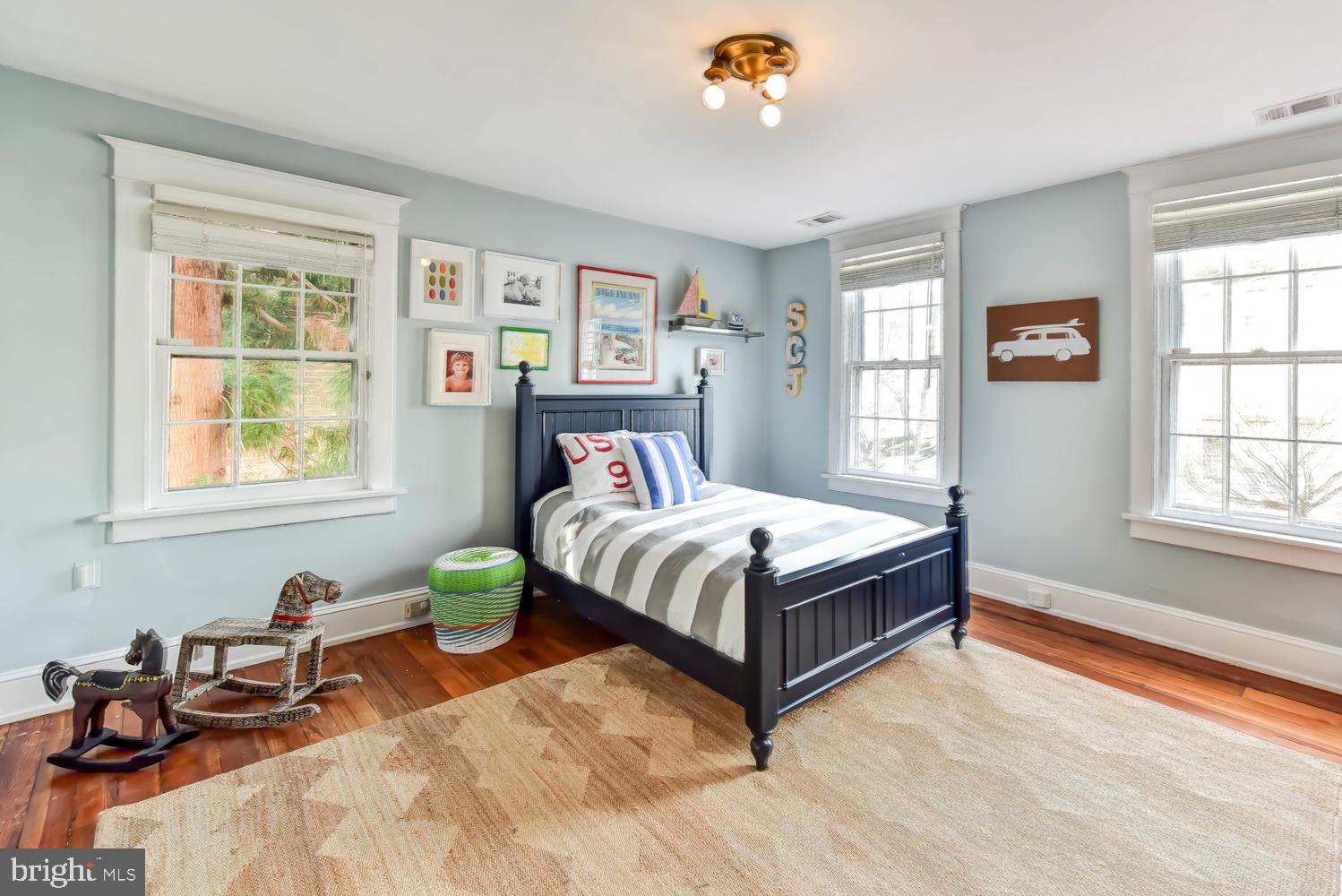 645 E Street Southeast Washington, DC 20003 - Photo 38 of 57 a bedroom with a bed and wooden floor