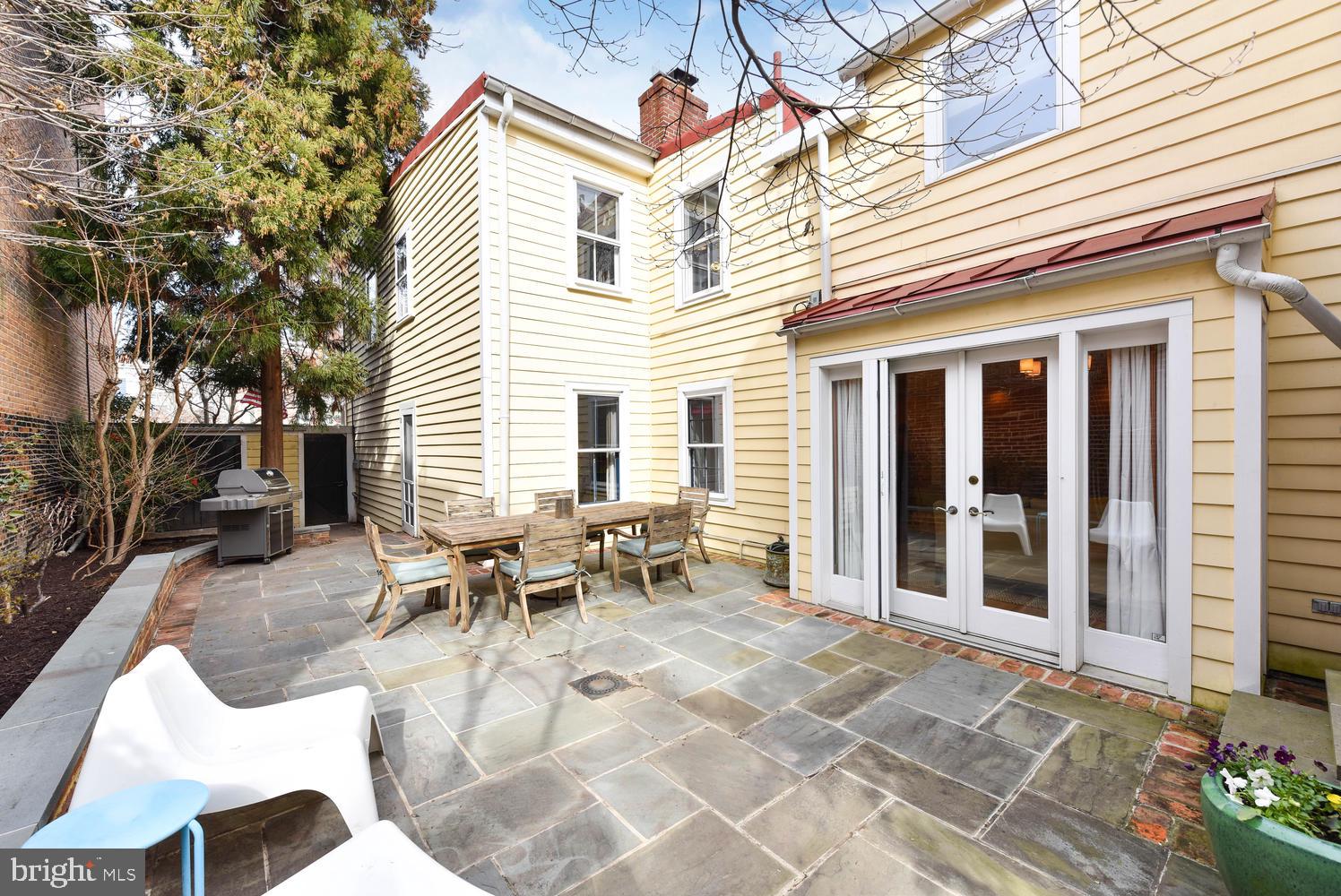 645 E Street Southeast Washington, DC 20003 - Photo 48 of 57 a view of a patio with table and chairs and floor to ceiling window