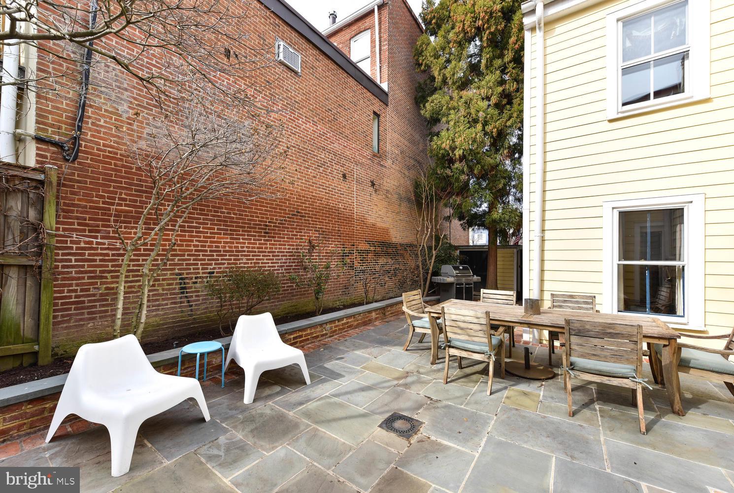 645 E Street Southeast Washington, DC 20003 - Photo 49 of 57 a view of a patio with a table and chairs and a barbeque