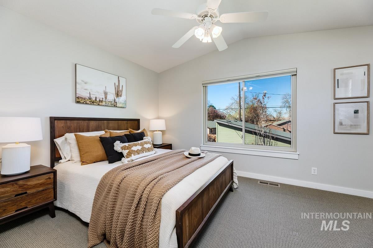 2045 Gourley Street Boise, ID 83705 - Photo 13 of 26 Bedroom with dark colored carpet, lofted ceiling, and ceiling fan