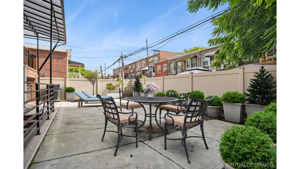 a view of a patio with table and chairs and potted plants