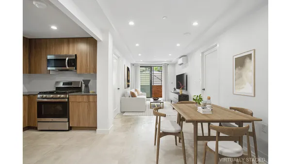 a living room with furniture and a mirror