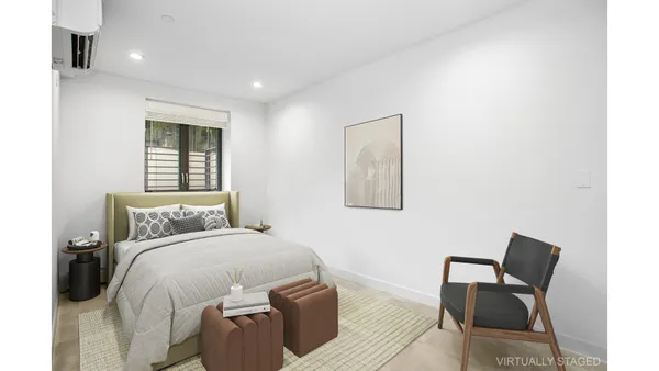 a bedroom with a bed and chair
