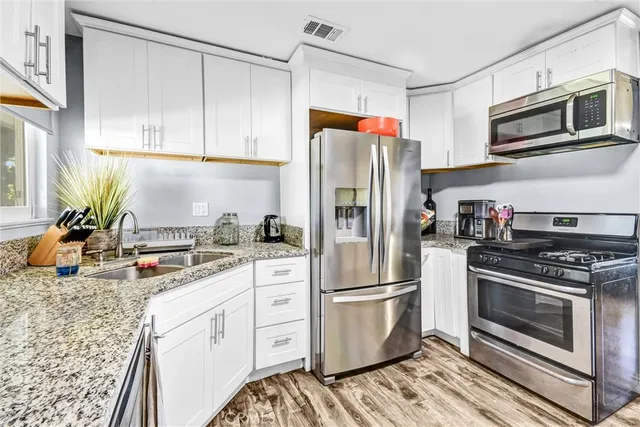 a kitchen with a sink stove and refrigerator