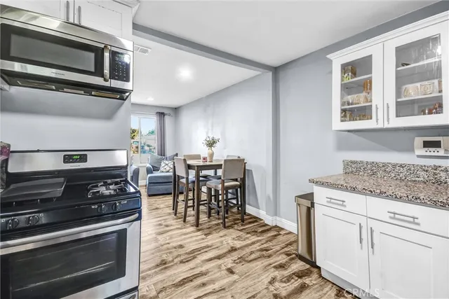 a kitchen with stainless steel appliances kitchen island a stove and a sink