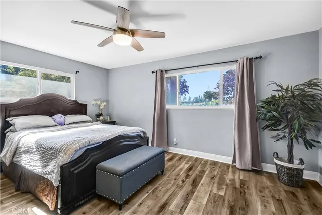 a bedroom with a large bed and a potted plant