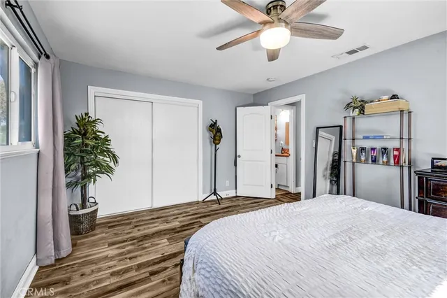 a bedroom with a bed and a potted plant