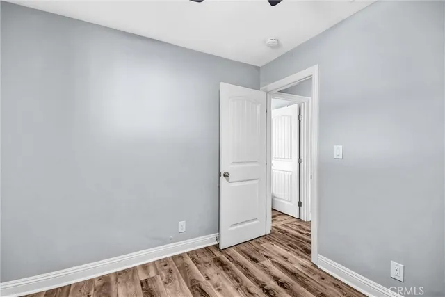 a bathroom with a granite countertop sink a toilet and a mirror