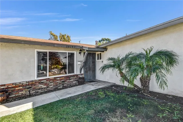 a front view of a house with a garden