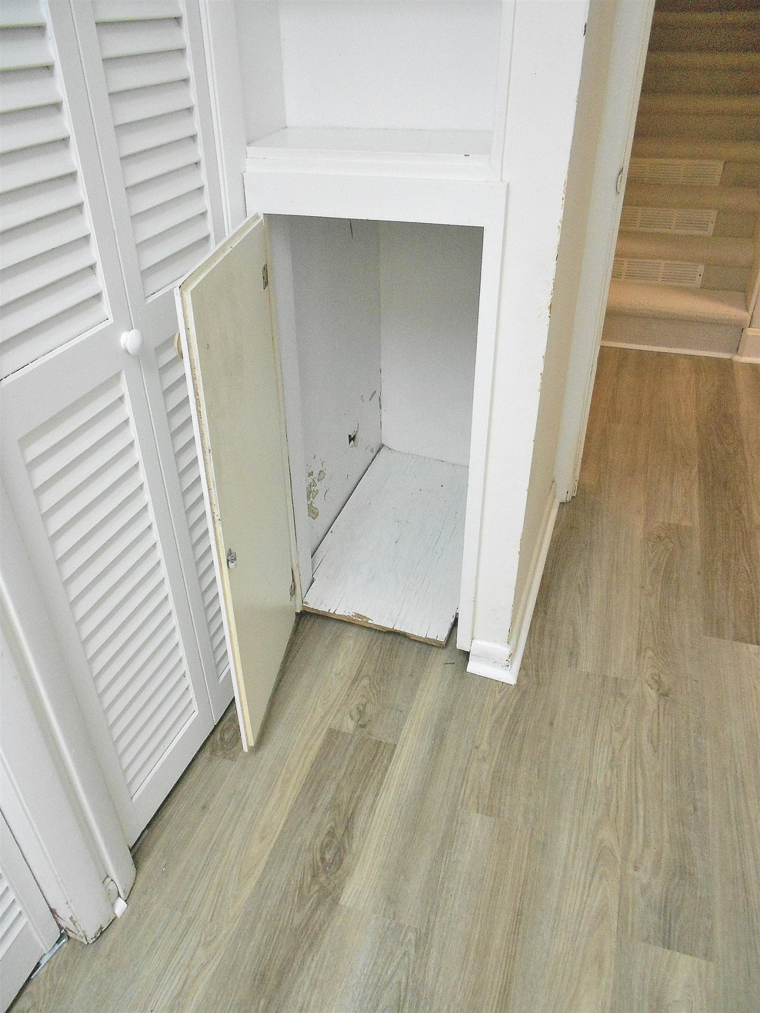 5805 Contour Drive Raleigh, NC 27612 - Photo 42 of 49 There is a laundry chute from the top floor hallway to the basement hallway beside the laundry closet Another old school detail