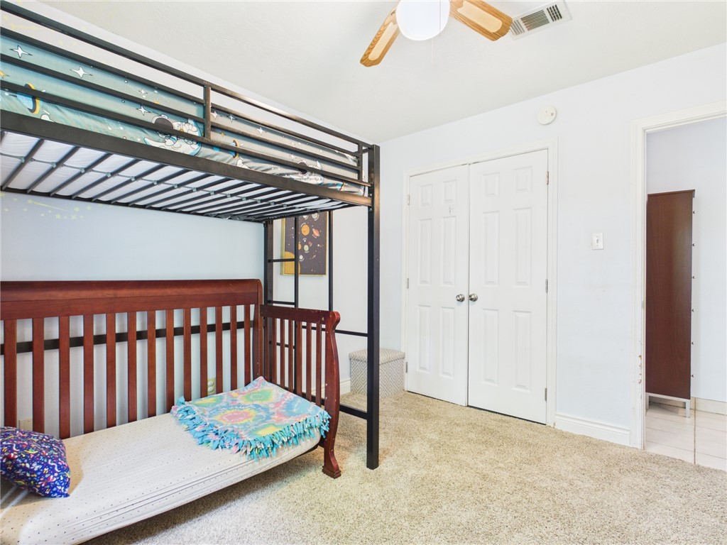 800 Rio Grande Lane Bryan, TX 77801 - Photo 13 of 23 a bedroom with furniture and a chandelier