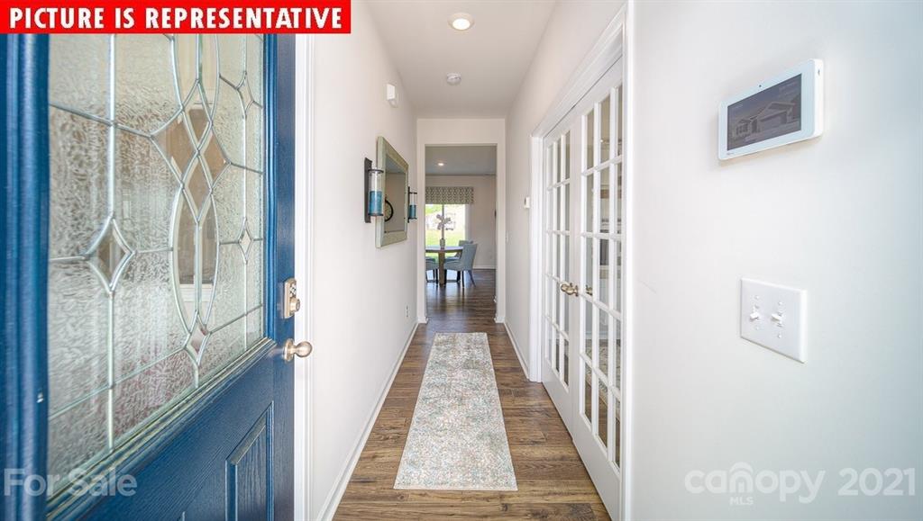 106 Sierra Road Mooresville, NC 28117 - Photo 2 of 32 a view of a hallway with wooden floor and windows