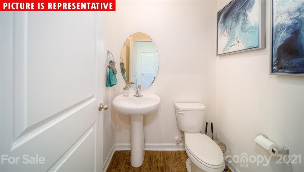 106 Sierra Road Mooresville, NC 28117 - Photo 18 of 32 a bathroom with a toilet sink and mirror