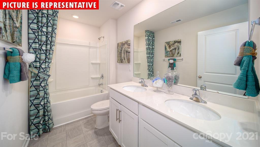 106 Sierra Road Mooresville, NC 28117 - Photo 21 of 32 a bathroom with a sink a toilet a tub and shower