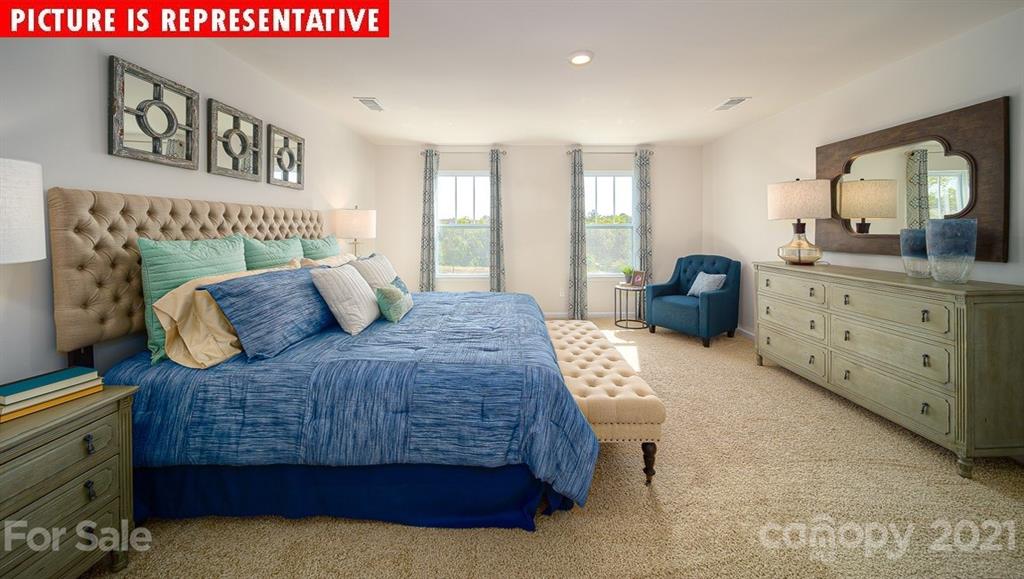 106 Sierra Road Mooresville, NC 28117 - Photo 23 of 32 a bedroom with a large bed and a dresser