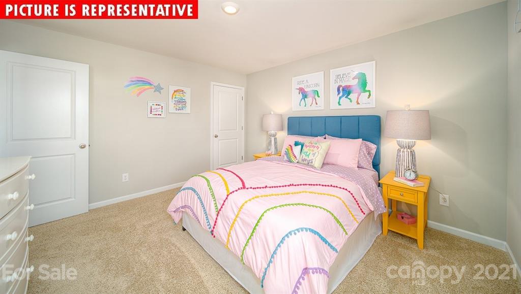 106 Sierra Road Mooresville, NC 28117 - Photo 30 of 32 a bedroom with a bed and a painting on the wall