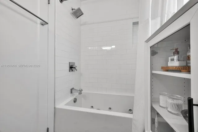 a bathroom with a bathtub and shower