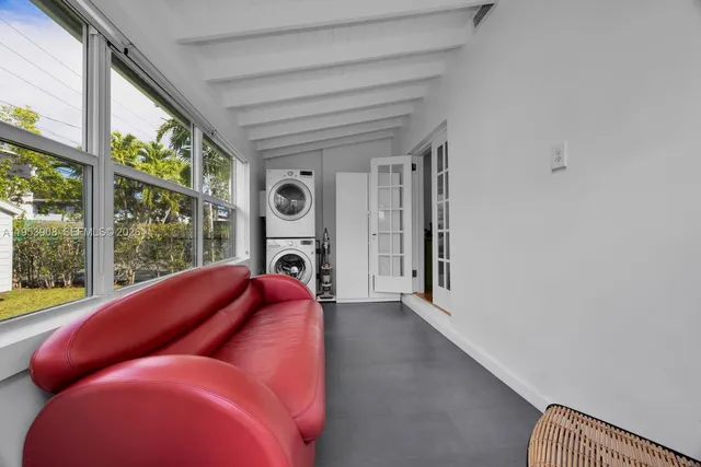 a living room with furniture and a floor to ceiling window