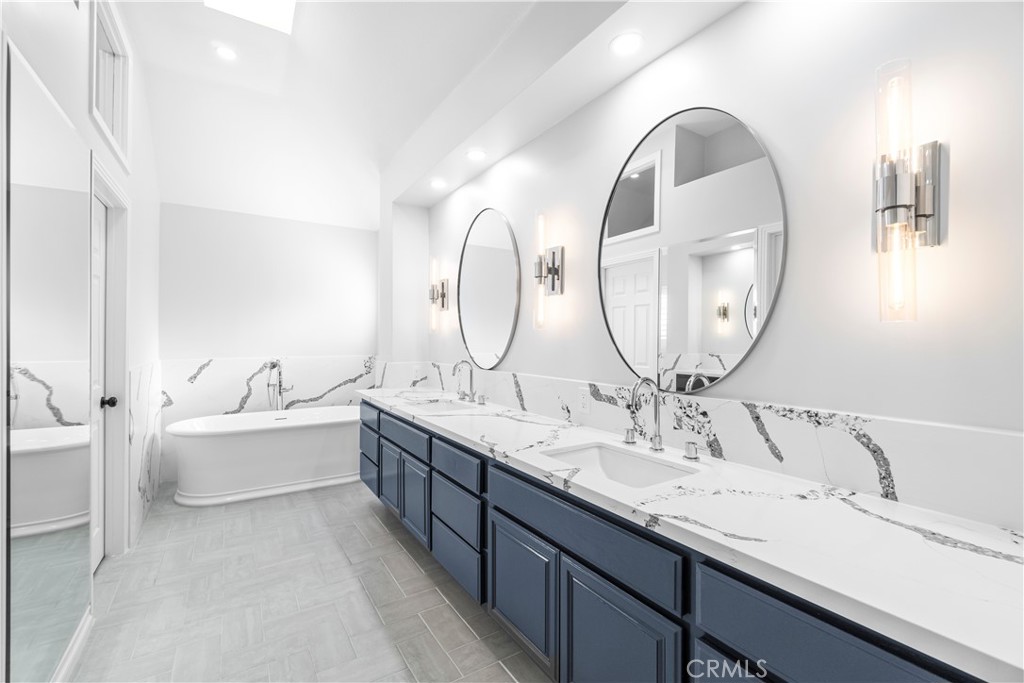 26433 Emerald Dove Drive Valencia, CA 91355 - Photo 14 of 50 a en suite bathroom with a double vanity sink and a mirror