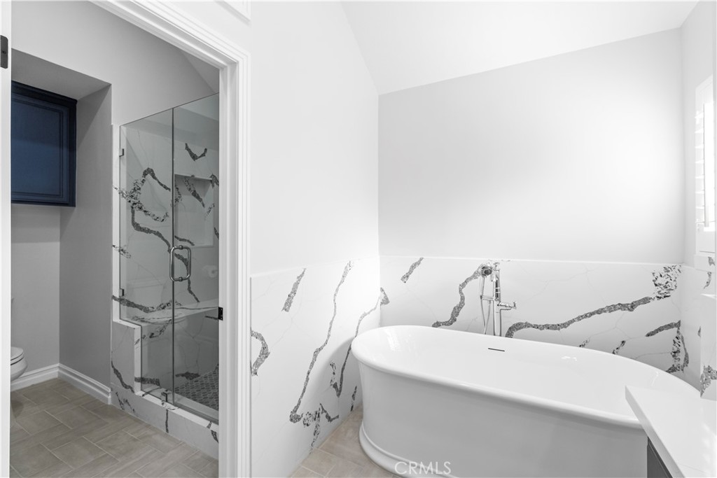 26433 Emerald Dove Drive Valencia, CA 91355 - Photo 15 of 50 a bathroom with a bathtub and shower