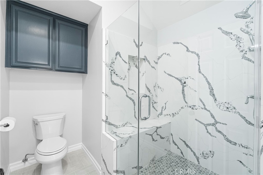 26433 Emerald Dove Drive Valencia, CA 91355 - Photo 16 of 50 a white toilet sitting next to a shower