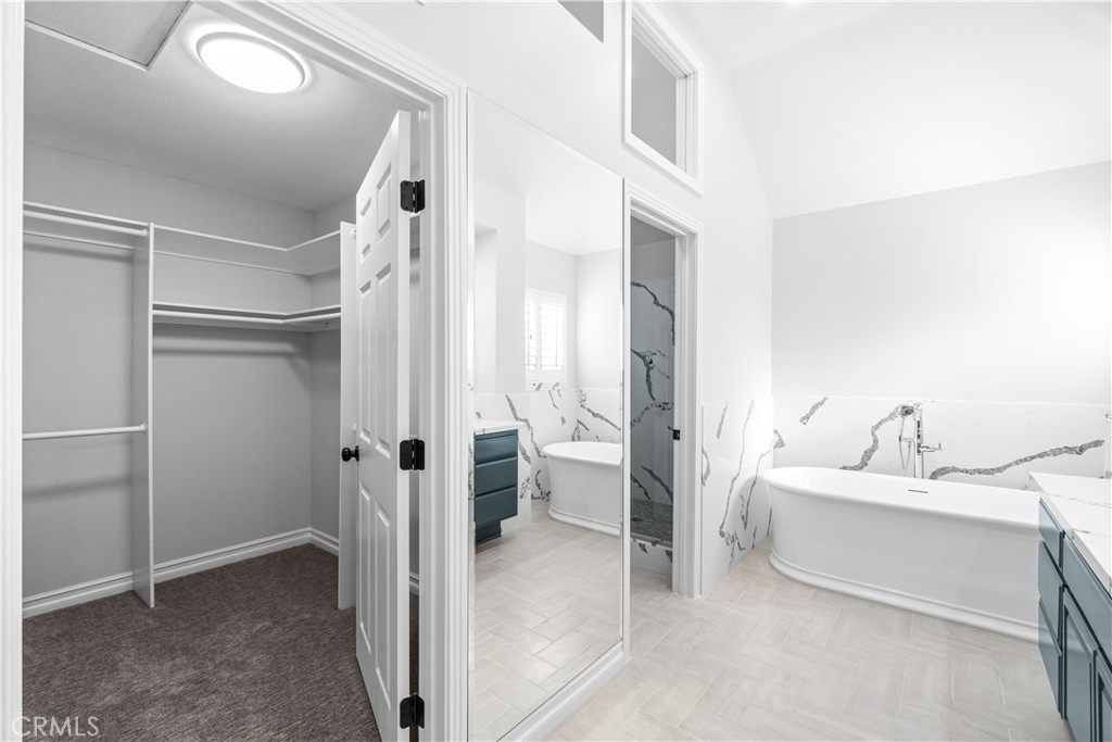 26433 Emerald Dove Drive Valencia, CA 91355 - Photo 17 of 50 a bathroom with a tub sink and mirror