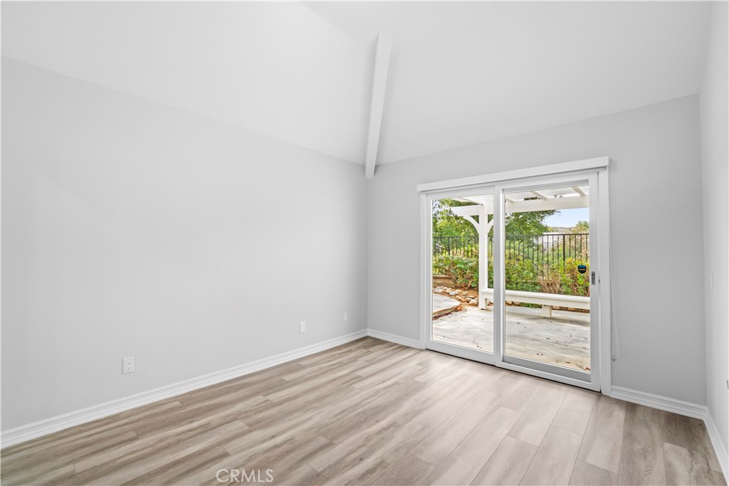 26433 Emerald Dove Drive Valencia, CA 91355 - Photo 26 of 50 an empty room with wooden floor and windows