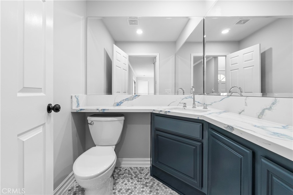 26433 Emerald Dove Drive Valencia, CA 91355 - Photo 31 of 50 a bathroom with a toilet sink and mirror