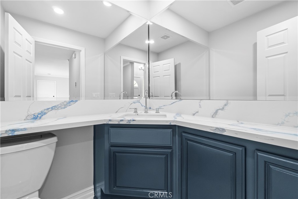 26433 Emerald Dove Drive Valencia, CA 91355 - Photo 32 of 50 a bathroom with a sink and a mirror