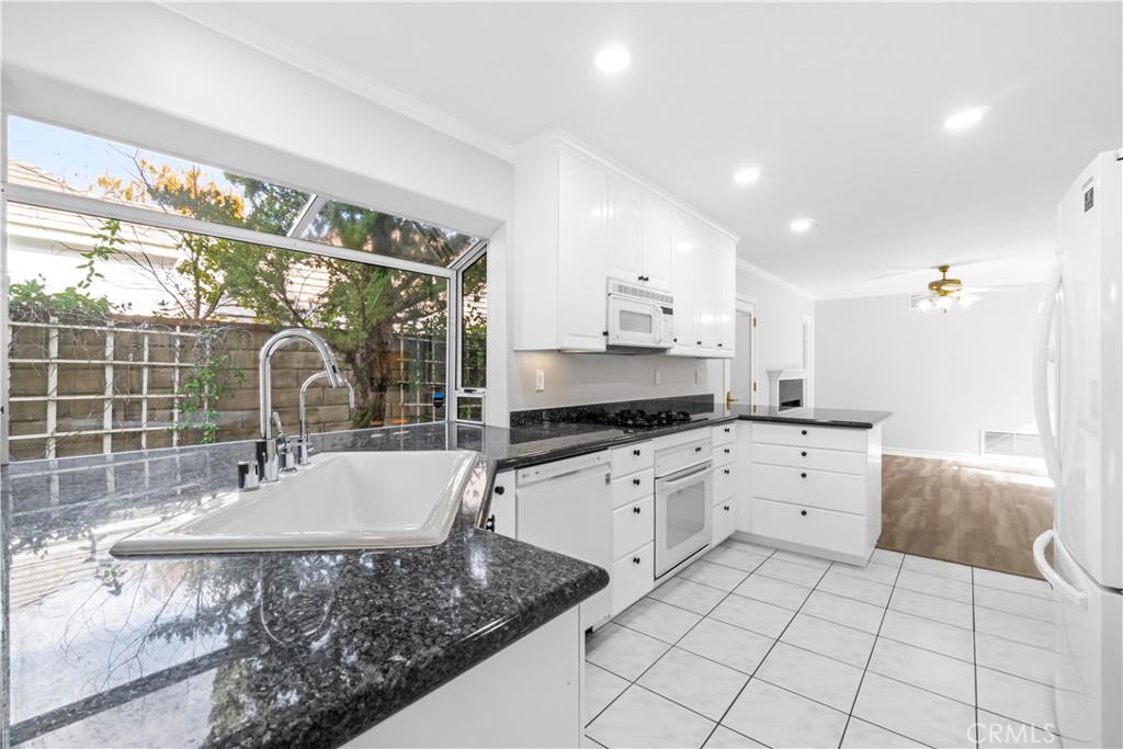26433 Emerald Dove Drive Valencia, CA 91355 - Photo 6 of 50 a kitchen with a sink stove and cabinets