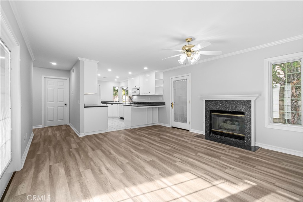 26433 Emerald Dove Drive Valencia, CA 91355 - Photo 9 of 50 a living room with a fireplace furniture a ceiling fan and a rug